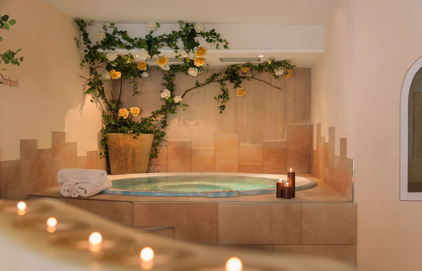 Circular jacuzzi with candles and soft lighting atmosphere in the spa at Hotel Waldheim