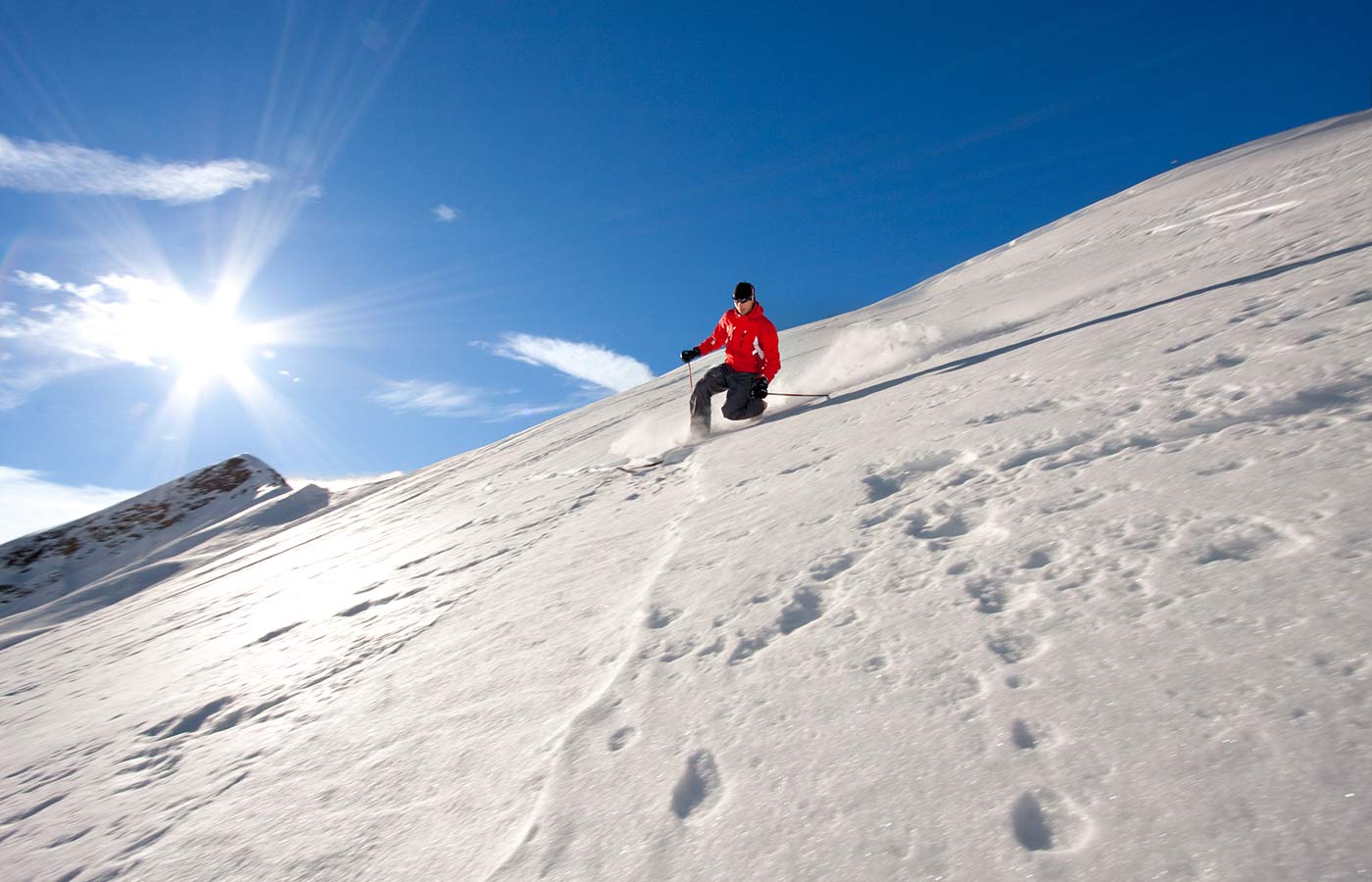 A skier practices telemark on a snow-covered slope on the mountain of South Tyrol in Italy